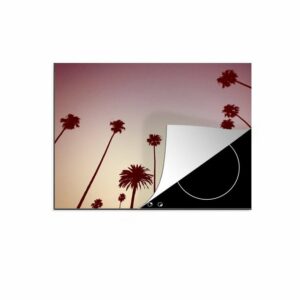 MuchoWow Herdblende-/Abdeckplatte "Die Silhouetten einer Reihe von Palmen vor einem rosa Himmel", Vinyl, (1 tlg), Mobile Arbeitsfläche nutzbar, Ceranfeldabdeckung